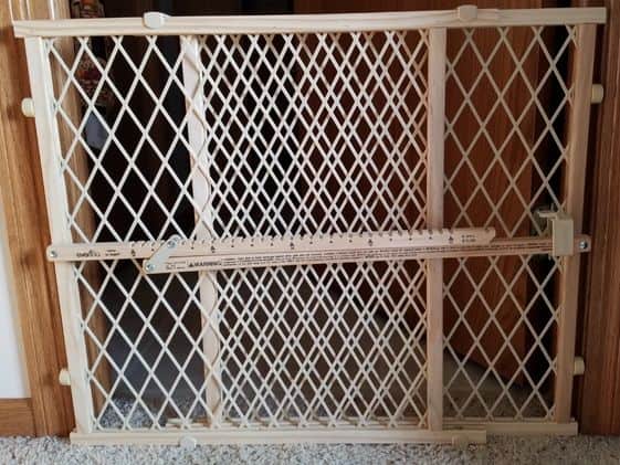A baby gate in a doorway.