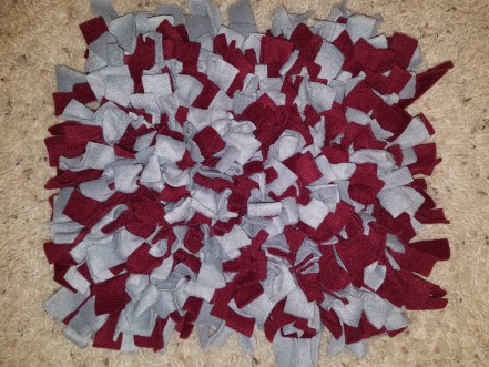 A gray and maroon snuffle mat.