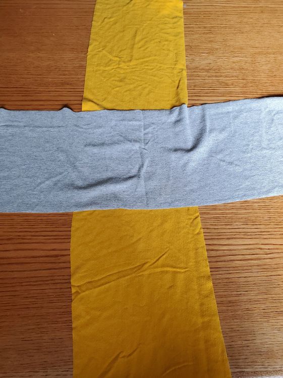Two wide tshirt strips laid out in a cross.