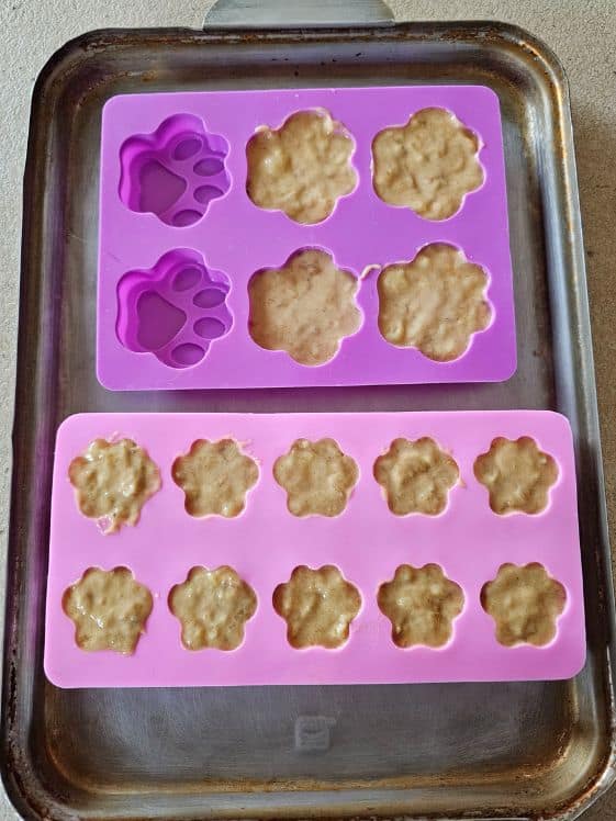 Paw shaped silicone molds filled, ready for the freezer.