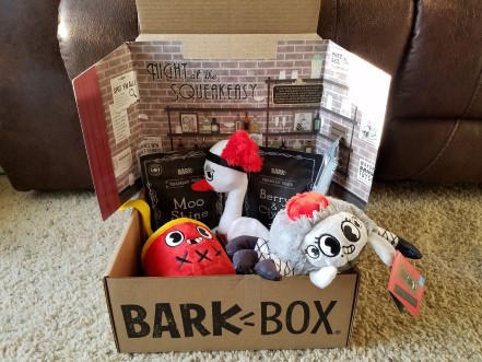 A bark box with stuffed toys and treats.