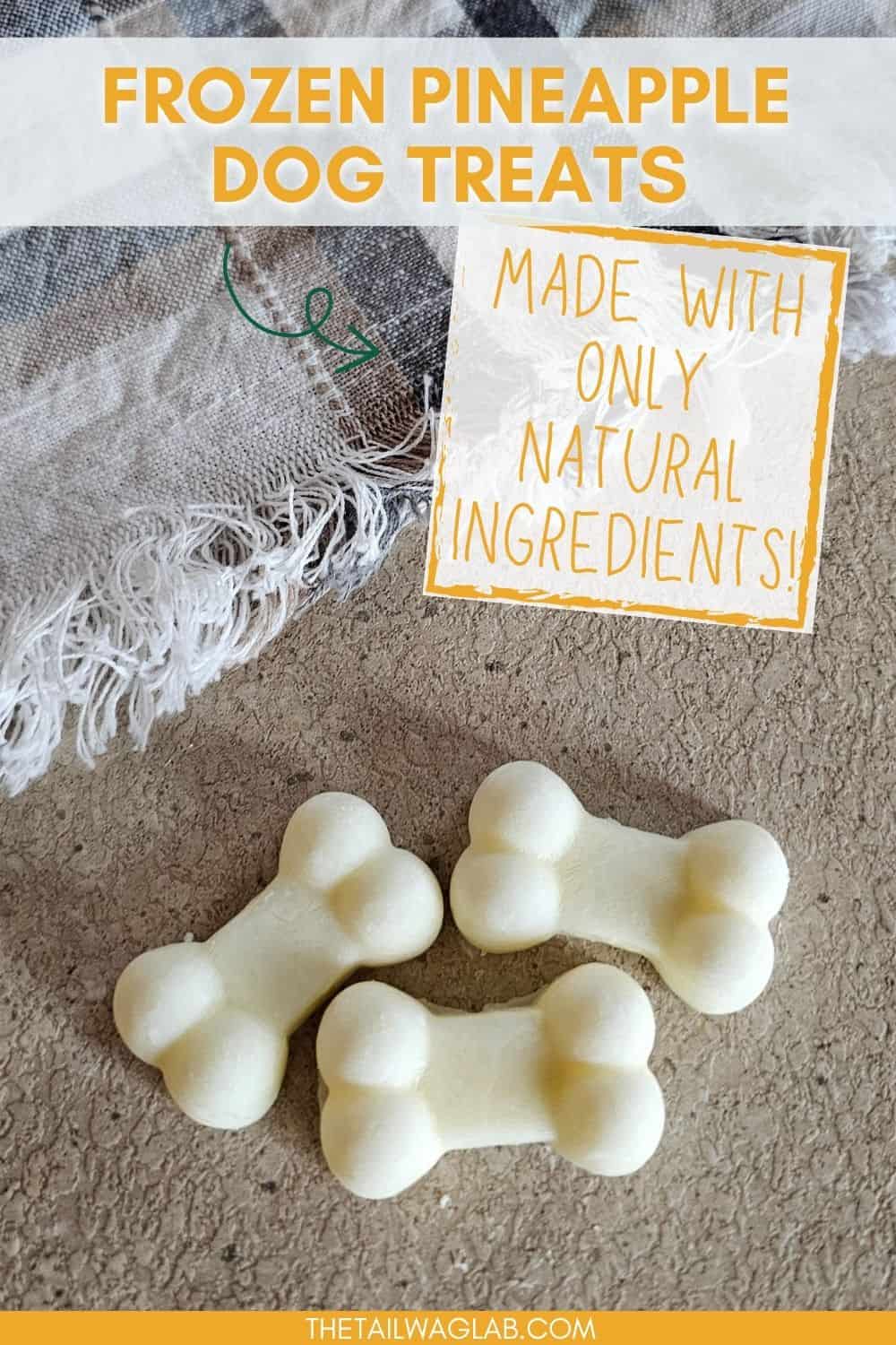 Three bone-shaped frozen pineapple dog treats are placed on a textured surface, accompanied by a caption stating they are made with only natural ingredients.