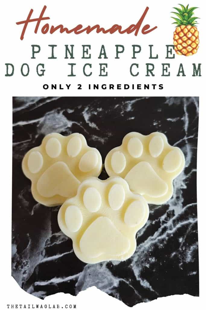 Three homemade pineapple dog ice cream treats shaped like paw prints are displayed against a dark marble background, promoting a recipe that uses only two ingredients for cold dog treats.