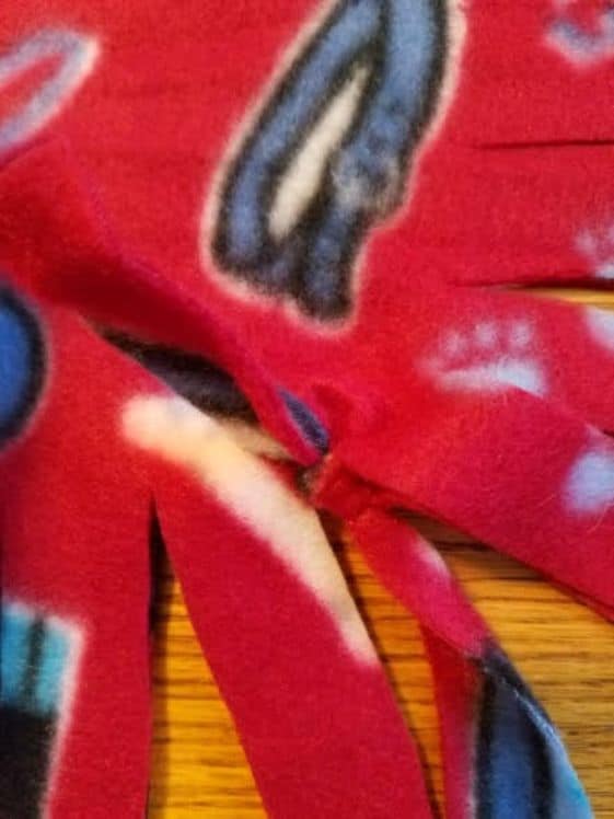 Fleece with a knot tied on the edge.