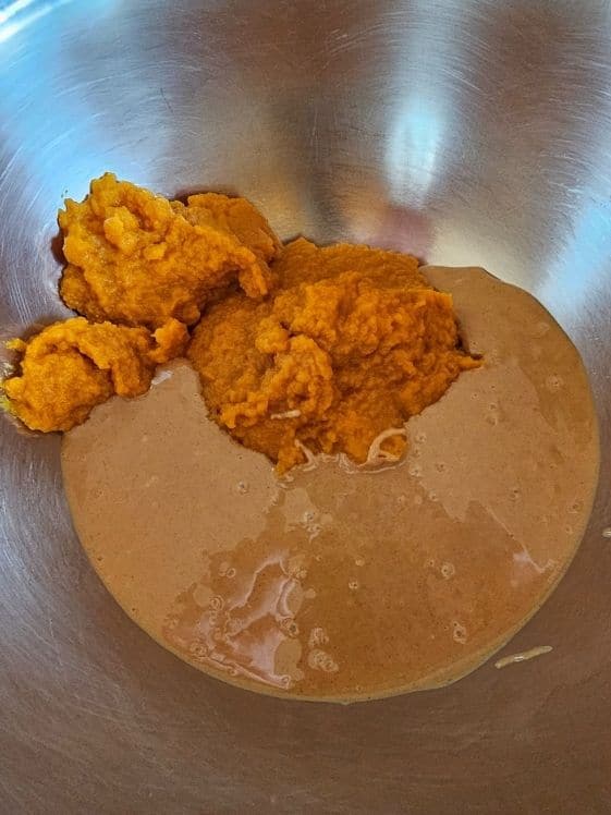Pumpkin puree and peanut butter in a mixing bowl.