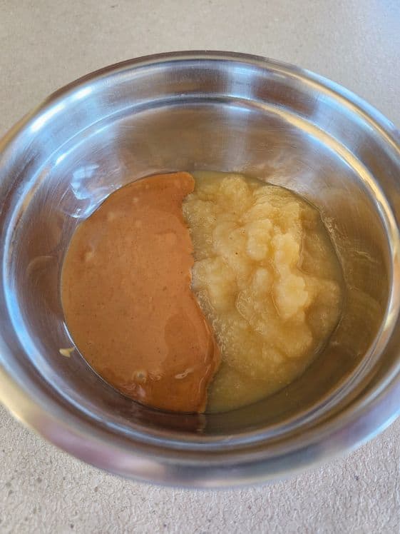 Peanut butter and applesauce in a mixing bowl.