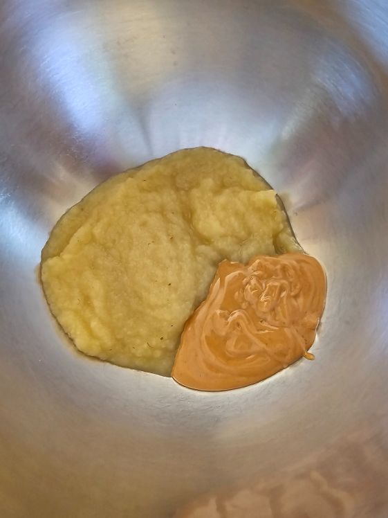 Applesauce and peanut butter in a mixing bowl.