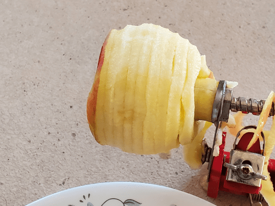 An apple after using the apple peeler, corer, slicer on it.