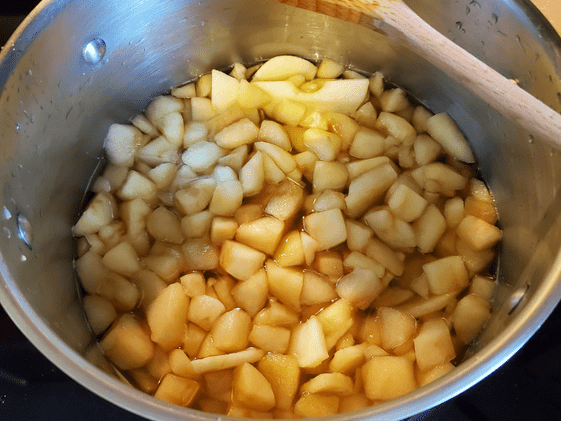 Chopped apples in a pot with water.