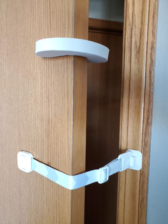 A door buddy strap and door stopper on a door.