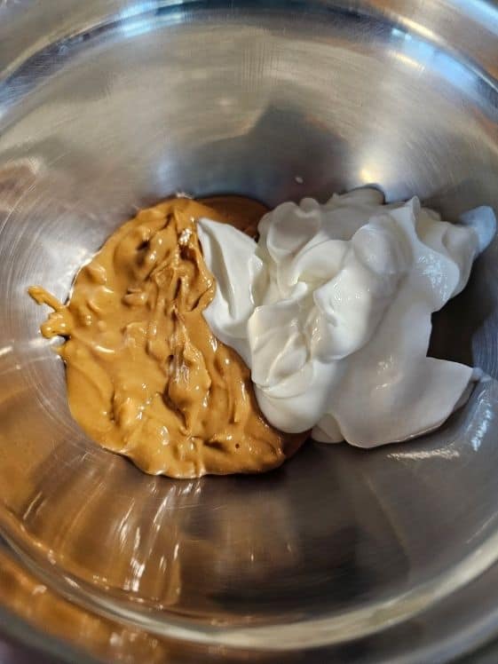 Peanut butter and Greek yogurt in a mixing bowl.