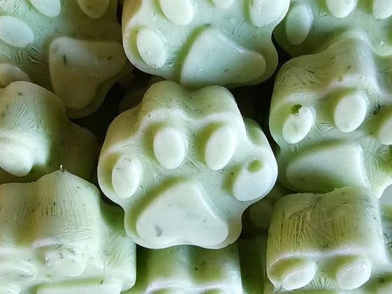 Close up of paw shaped frozen fresh breath dog treats.
