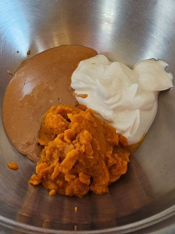 Peanut butter, Greek yogurt, and pumpkin puree in a mixing bowl.