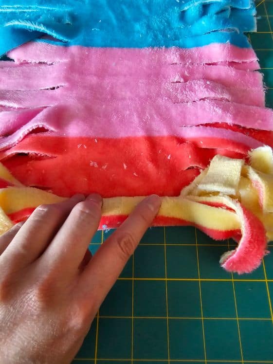 Rolling the fleece tightly.
