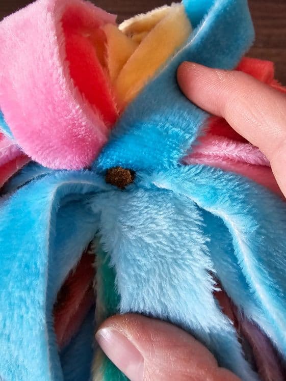 Add treats to the fringe snuffle ball.