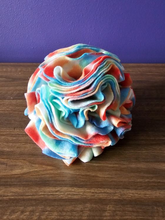 A finished snuffle ball made from fleece circles.