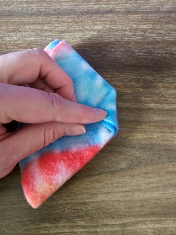 Pointed end folded over to make a slit.