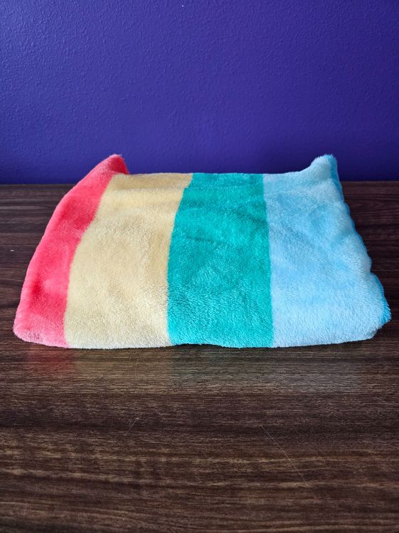 A rainbow fleece blanket.