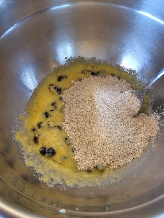 Wheat flour added to the blueberry applesauce and egg mixture.