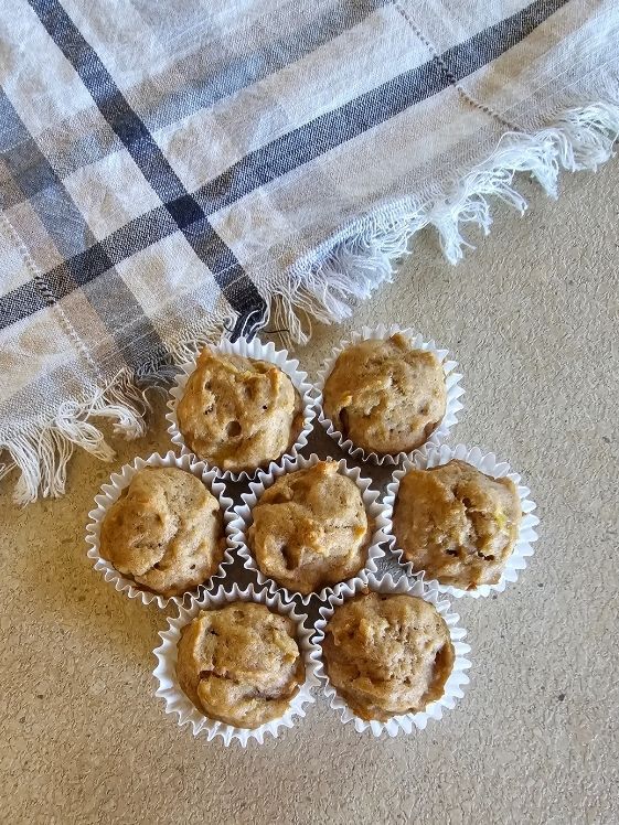 Banana dog muffins next to a linen towel.