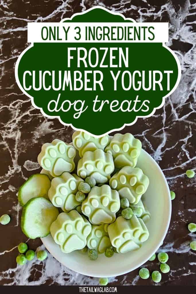 Green paw-shaped frozen cucumber yogurt treats in a white bowl with cucumber and peas, with text reading “Only 3 Ingredients Frozen Cucumber Yogurt Dog Treats.”