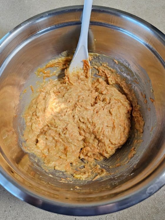 Wet ingredients, pineapple, and carrots mixed together.