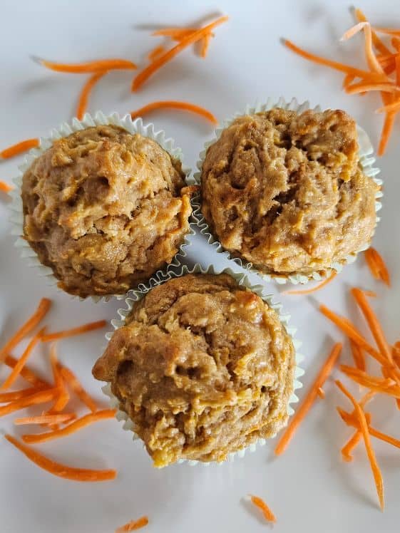 Finished carrot pineapple pupcakes with shredded carrots around them.