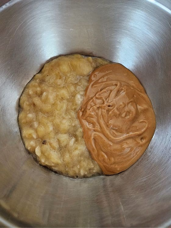 Mashed banana and peanut butter in a bowl.