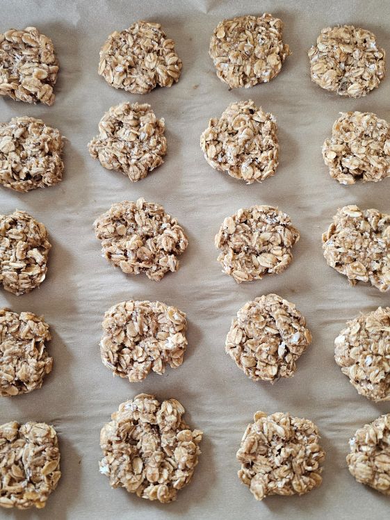 Banana oat treats on lined cookie sheet.