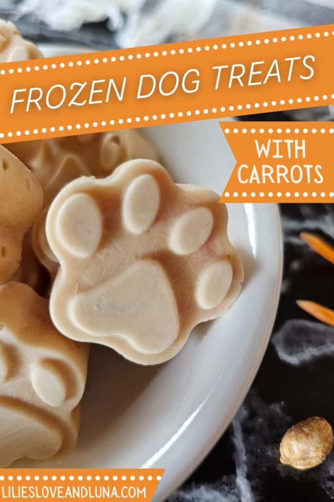 A close-up of paw-shaped frozen dog treats made with carrots, displayed in a white bowl.