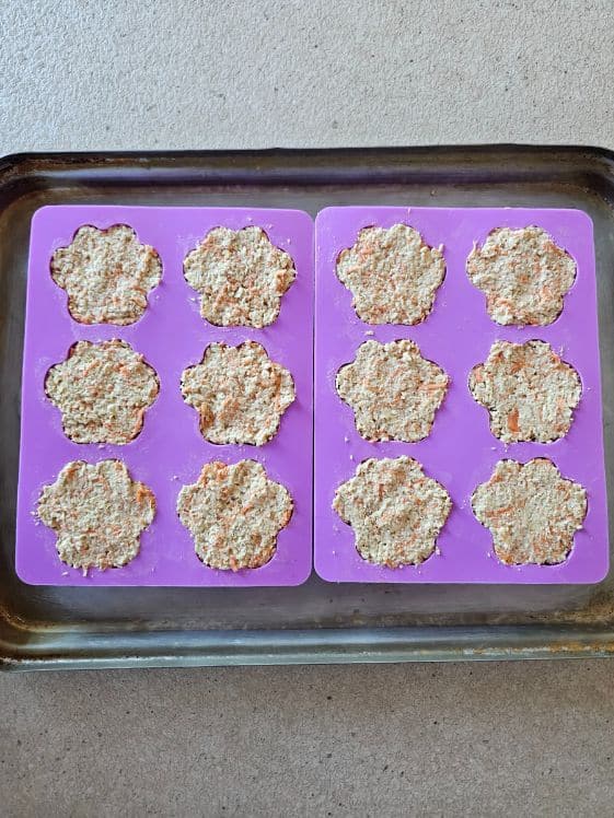 Paw shaped molds filled and ready to bake.