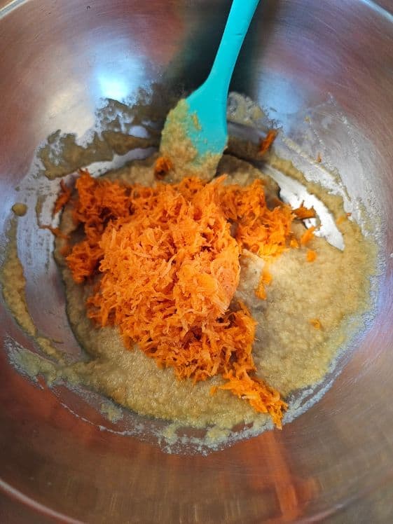 Shredded carrot added to wet ingredients.
