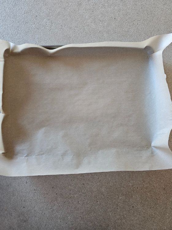 A piece of parchment paper on a baking sheet.