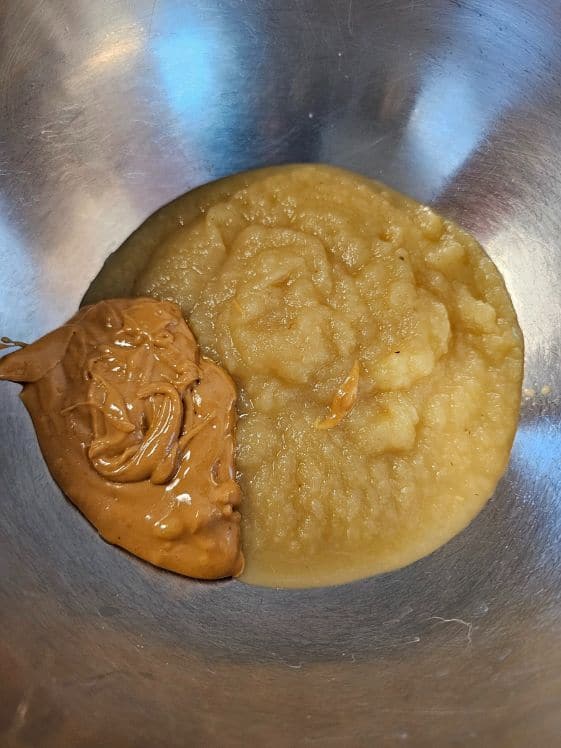Applesauce and peanut butter in a mixing bowl.