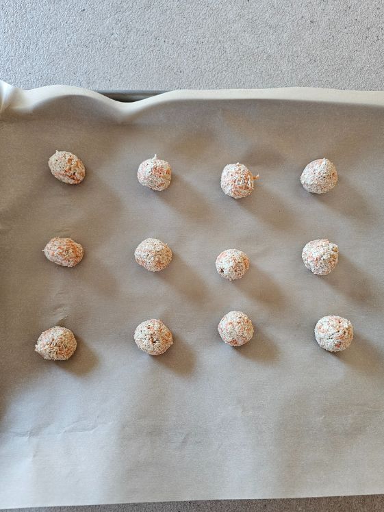 Treat balls on a parchment paper lined baking sheet.