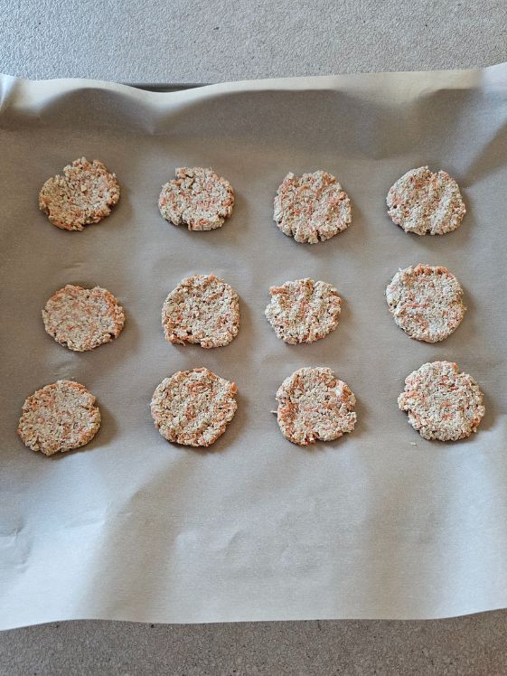Flattened round treats before baking.