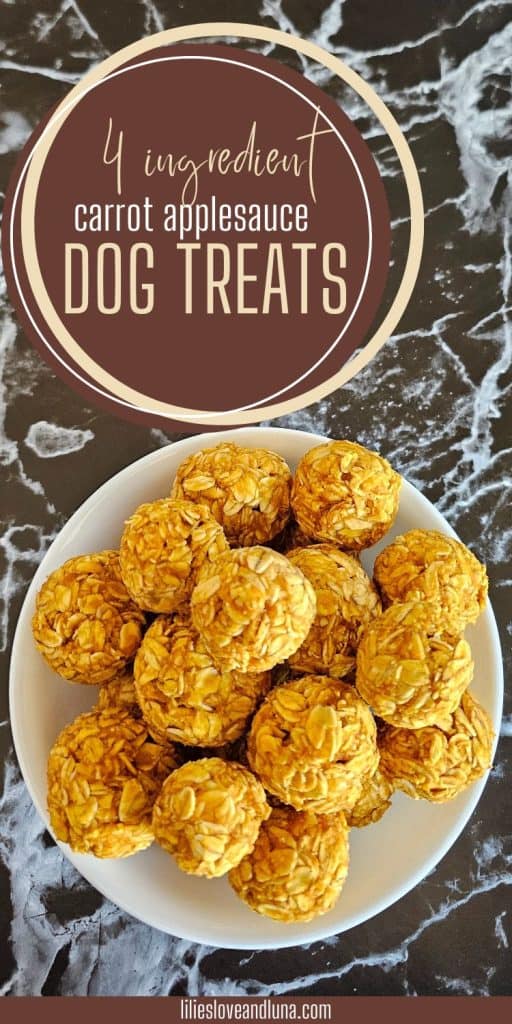 A plate of four-ingredient carrot applesauce dog treats, resembling small balls, is displayed on a marble surface.