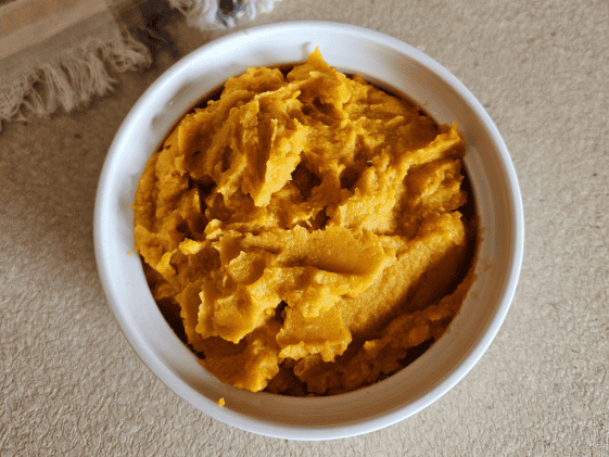 Sweet potato puree in a white bowl.
