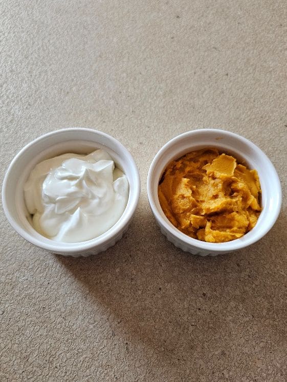 A bowl of Greek yogurt next to a bowl of sweet potato puree.