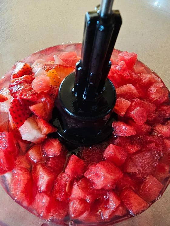 Chopped strawberries and watermelon in a food processor.