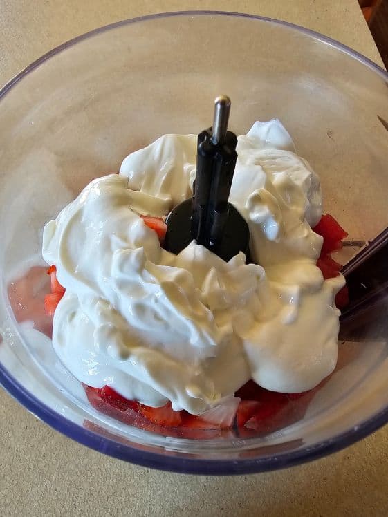 Strawberries, watermelon, and Greek yogurt in a food processor.