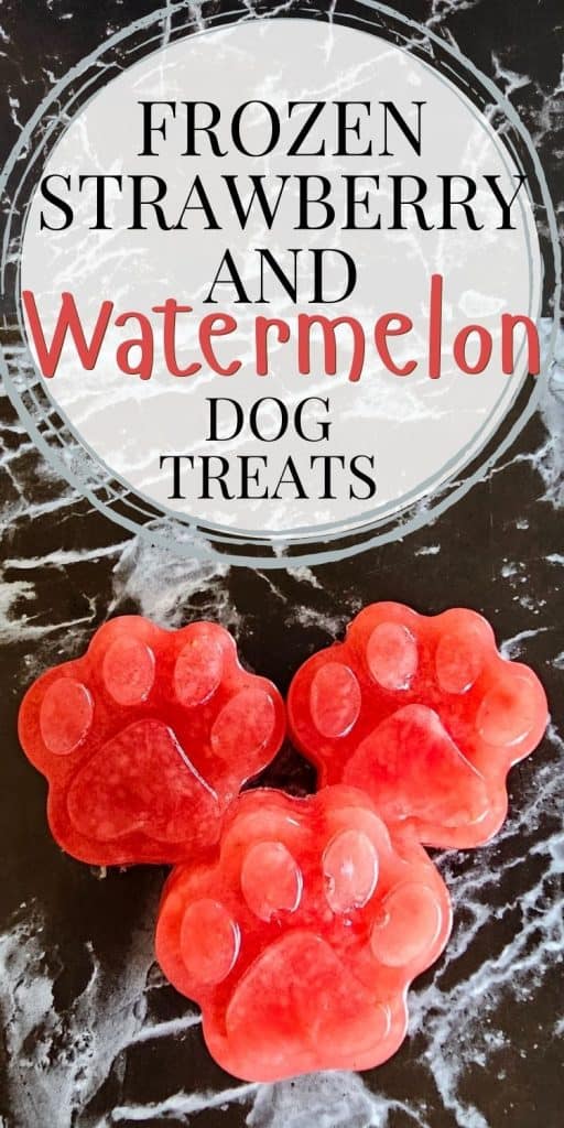 Frozen strawberry and watermelon paw-shaped dog treats are displayed on a marble surface, offering a refreshing option for summer dog snacks.