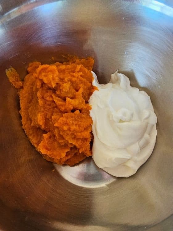Pumpkin puree and Greek yogurt in a mixing bowl.