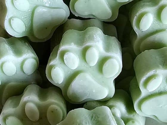 Close up of paw shaped frozen cucumber mint dog treats.