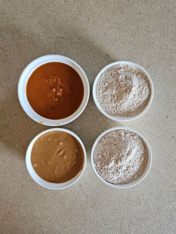 Sweet potato puree, peanut butter, and wheat flour in individual white bowls.
